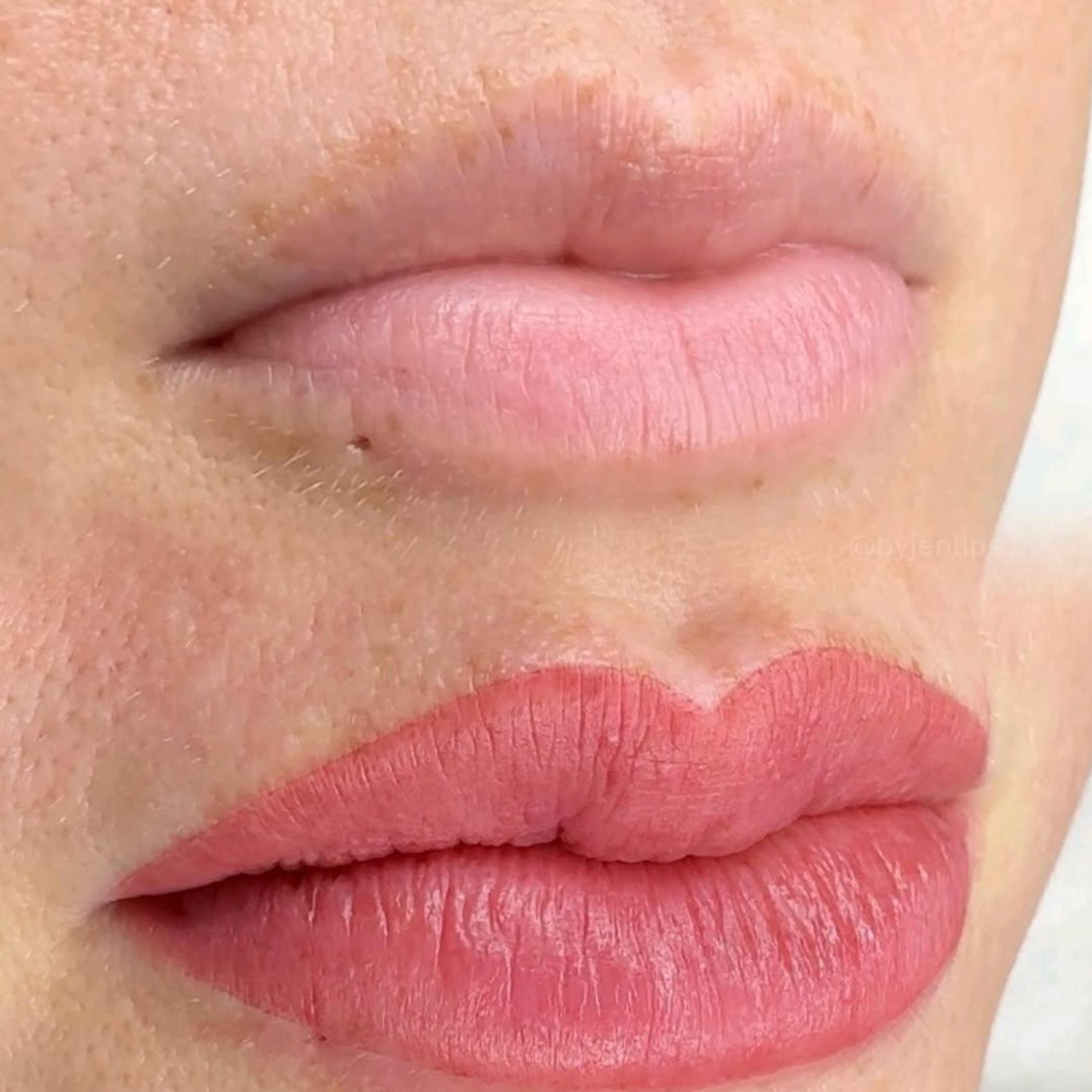lip tattoo artist performing procedure